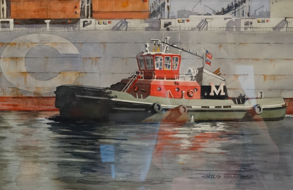 A red tugboat leaving the dock